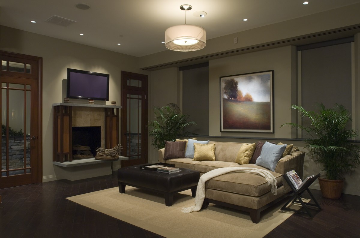 Elegant living room with fine art and rich wood accents illuminated by Lutron lighting controls.