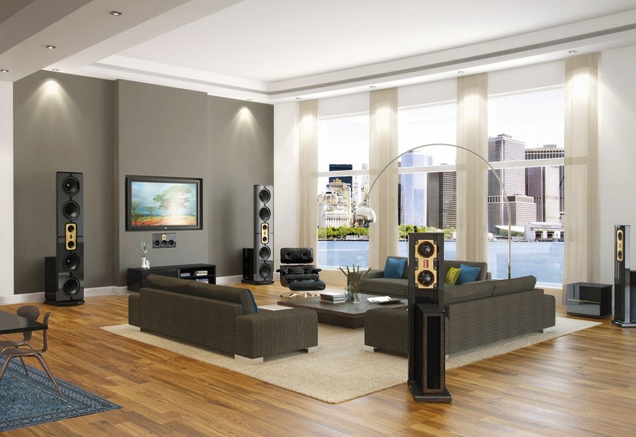 Sophisticated living room with high-end audio speakers overlooking a city across a lake. 