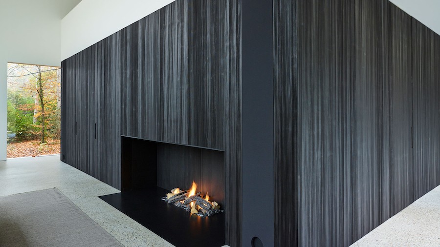 A close-up of a home audio speaker neatly integrated into a fireplace wall in Vail. 